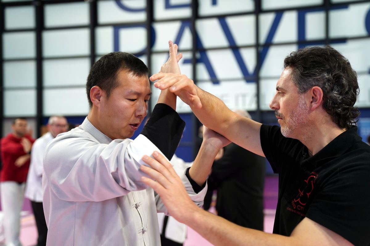 Two Kung Fu practitioners in a close-range Wing Chun partner drill
