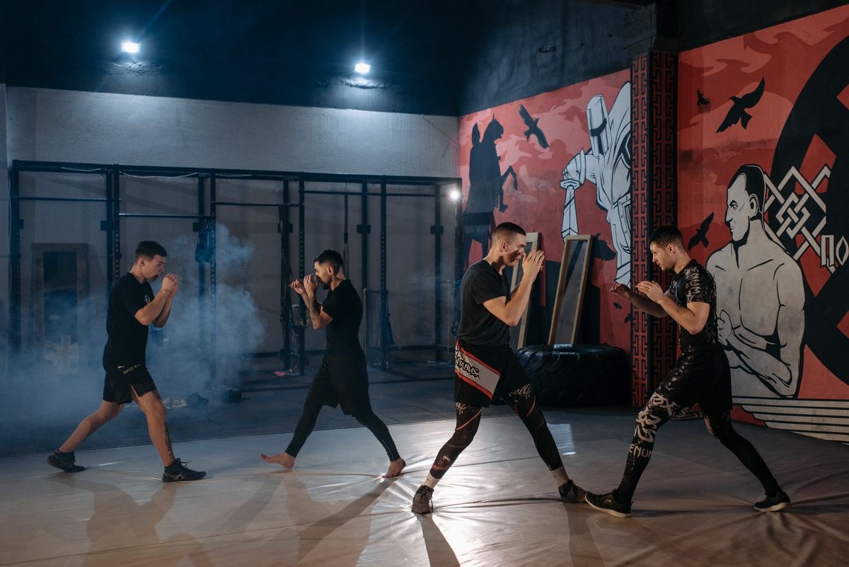 A group of MMA students shadow boxing together in a training room