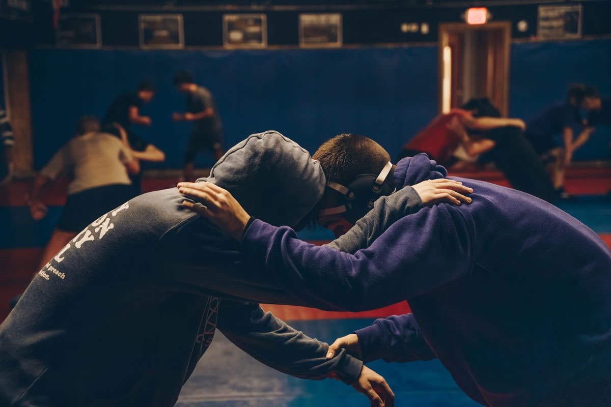 Young wrestlers drilling hand fighting and tie-ups at practice